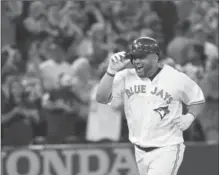  ??  ?? Toronto Blue Jays designated hitter Kendrys Morales celebrates as he rounds the bases after his walkoff solo homer in the ninth inning.