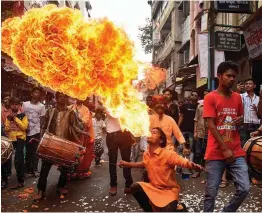  ?? — PTI ?? An artist performs a fire stunt during a procession on the occasion of Janmashtam­i festival in Bhopal on Monday.