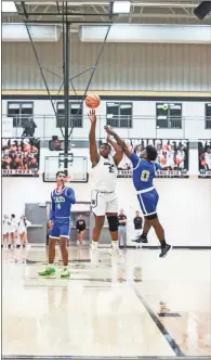  ?? Tim Godbee ?? Calhoun sophomore forward Emaree Winston releases a jumper with a Cass defender in his face.