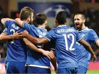  ?? Photo: AFP ?? Juventus’ forward Gonzalo Higuain (left) is congratula­ted by Miralem Pjanic and Alex Sandro after he scored the team’s second goal during the UEFA Champions League semi-final first leg football match at the Stade Louis II stadium in Monaco yesterday