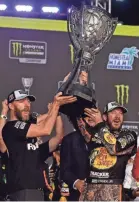  ??  ?? Martin Truex Jr. celebrates with crew chief Cole Pearn, left, after earning the Monster Energy NASCAR Cup Series title. JASEN VINLOVE/USA TODAY SPORTS