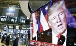  ?? RICHARD DREW — THE ASSOCIATED PRESS FILE ?? An image of President-elect Donald Trump appears on a television screen on the floor of the New York Stock Exchange. Last year, investors calmly brushed aside every surprise that came out of Capitol Hill or the White House. Now, markets are moving...