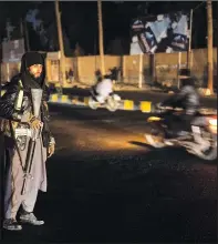  ?? ?? A Taliban fighter
stands Nov. 28 at a checkpoint in Herat.