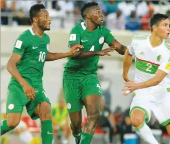  ??  ?? L-R: Super Eagles John Mikel Obi and Kenneth Omeruo battling an Algerian forward when the Fennecs were in Uyo for the Matc-day Two of the FIFA World Cup qualifiers in November 2016