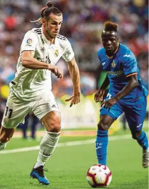  ?? EPA PIC ?? Real Madrid’s Gareth Bale (left) and Getafe’s Amath Ddiaye vie for the ball at the Santiago Bernabeu on Sunday.