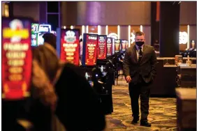  ?? (Arkansas Democrat-Gazette/Stephen Swofford) ?? A member of security walks among tables Tuesday as people play craps, roulette and blackjack at the Saracen Casino in Pine Bluff.