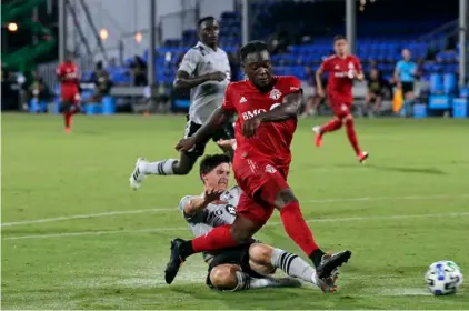  ?? AP Photo/John Raoux ?? Toronto FC forward Ayo Akinola, front, scores his second goal of the game during the first half of an MLS soccer match against the Montreal Impact in Kissimmee, Fla., in this 2020 file photo.