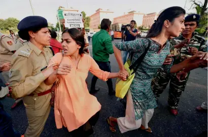  ?? — PTI ?? Police detain JNU students during a protest over a missing varsity student Najeeb Ahmed, in New Delhi.