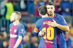  ?? AFP ?? Barcelona forward Luis Suarez celebrates a goal with Lionel Messi in their Champions League quarterfin­al first leg with Roma at the Camp Nou on Wednesday night.