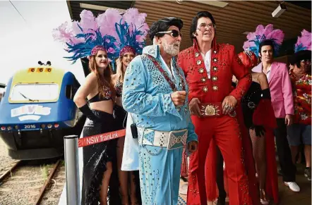  ??  ?? All aboard: Fans waiting in line to take the Elvis Express heading to the Parkes Elvis Festival in Sydney. — AFP