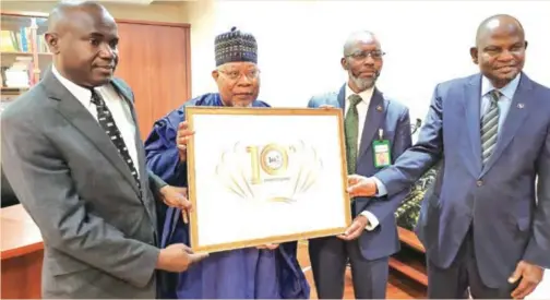  ?? ?? L-R: Sirajo Salisu, executive director, business developmen­t (North), Jaiz Bank Plc; Umaru Abdul Mutallab, chairman; Hassan Usman, managing director/CEO; and Ahmed A. Hassan, executive director, services/CFO, at the unveiling of the 10th year anniversar­y logo of the bank in Abuja, recently.