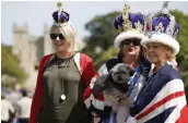  ?? — AFP ?? Royal fans ( right) bedecked with flags and crowns pose along the Long Walk in Windsor.