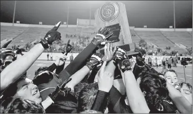  ?? Special to the Democrat-Gazette/JIMMY JONES ?? Charleston players celebrate with the trophy after defeating Glen Rose 42-19 in the Class 3A championsh­ip game Saturday night at War Memorial Stadium in Little Rock. It was the Tigers’ fourth state title.