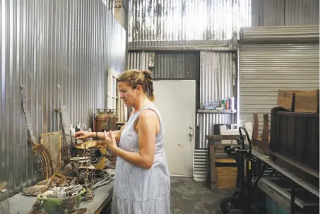  ?? Photos by Lea Suzuki / The Chronicle ?? Sculptor Helena Donzelli looks through pieces of debris she has collected after the North Bay fires. Donzelli lost her Glen Ellen studio home but is renting a Sonoma studio that she shares with two other artists who also lost their work spaces in the blazes.