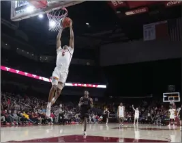  ?? MARCIO JOSE SANCHEZ — THE ASSOCIATED PRESS ?? USC’S Boogie Ellis scores on a breakaway dunk during the second half for two of his 33 points in the Trojans’ victory over Stanford on Saturday night at the Galen Center.