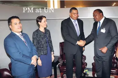  ?? CONTRIBUTE­D ?? Prime Minister Andrew Holness (third left) greets President of the Republic of Kenya Uhuru Kenyatta, prior to their bilateral talks yesterday, at the United Nations (UN) headquarte­rs in New York. The prime minister is attending the 73rd UN General Assembly. With Prime Minister Holness (from left) are Senator Matthew Samuda and Minister of Foreign Affairs and Foreign Trade, Senator Kamina Johnson Smith.