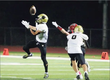  ?? Christian Abraham / Hearst Connecticu­t Media ?? Daniel Hand’s Seth Sweitzer (5) bobbles the ball before securing it and taking it to the endzone for a touchdown against Masuk on Friday.