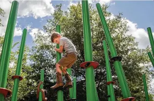  ?? Photos by Marie D. De Jesús / Staff photograph­er ?? Jay Rotolo, 5, plays at the Houston Arboretum & Nature Center’s Nature Playscape, a beautifull­y designed recreation­al feature. Other unveiled improvemen­ts include restored grassland and trails.