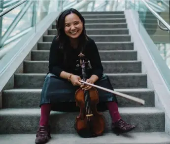  ?? BRIAN B. BETTENCOUR­T/TORONTO STAR ?? “The viola changed my life,” attests the Toronto Symphony Orchestra’s principal violist Teng Li, seen on the steps inside Roy Thomson Hall this month. The Chinese-born performer joined the TSO in the 2004-05 season.