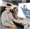  ?? SUSAN STOCKER/STAFF PHOTO ?? Evan Scolnick, 17, tries American Airlines' virtual reality headset.