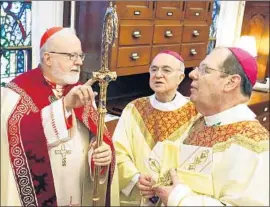  ?? Gabe Souza Pool Photo ?? THEN-APOSTOLIC Nuncio Carlo Maria Vigano, center, is pictured in 2014 with Cardinal Sean O’Malley, left, and Bishop Robert Peter Deeley, in Portland, Maine.