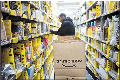  ?? AP file photo ?? A clerk works at the Amazon Prime warehouse in New York City in December. Amazon says it plans to spend as much as $5 billion to build its second headquarte­rs.