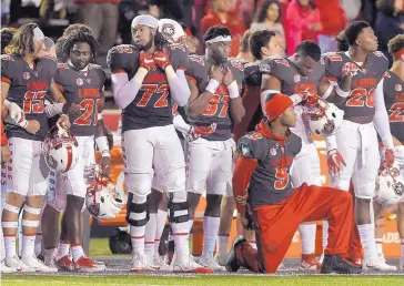  ?? ROBERTO E. ROSALES/JOURNAL ?? Lobo defensive back Stanley Barnwell kneels during an unexpected playing of the national anthem at halftime of UNM’s 2017 game against Air Force. Of five UNM players who knelt, Elijah Lilly is the only one still in the program.