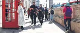  ??  ?? Armed British policemen patrol a street in London on Wednesday.