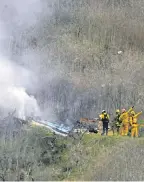  ?? MARK J. TERRILL/ AP ?? Firefighters work the scene of the helicopter crash in Calabasas, California, where Kobe Bryant and eight others died.