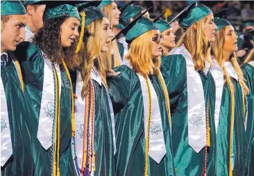  ?? CHELSEY COX/SANTA FE INDEPENDEN­T SCHOOL DISTRICT ?? Students attend the Santa Fe High School graduation ceremony in Santa Fe, Texas, on Friday. The students are wearing white stoles with the word “strong” in tribute to those slain in a shooting two weeks ago.