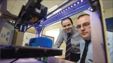  ??  ?? Diarymaste­r CEO and Technical Director Dr Edmond Harty and David Fleming from the Dairymaste­r Design Department watch as a prototype component is produced in one of the factory’s high spec rapid 3D printers