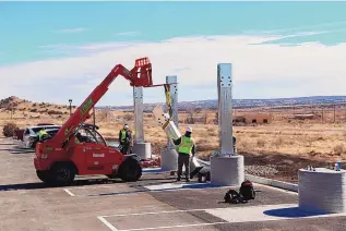  ??  ?? OE Solar employees set up the foundation­s for a solar carport at Laguna Pueblo.