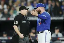  ?? NATHAN DENETTE — THE CANADIAN PRESS VIA AP ?? Toronto Blue Jays interim manager John Schneider talks with home plate umpire Todd Tichenor (13) during the fifth inning of Game 2 of the baseball team’s AL wild-card playoff series against the Seattle Mariners. Schneider went 42-26 as interim manager and the club has to decide if it wants to give the Lawrence High product the job on a fulltime basis.