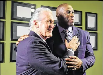  ?? GETTY IMAGES ?? The Heat’s Pat Riley and the Lakers’ Magic Johnson get together at an American Express promotion on Monday in Los Angeles.