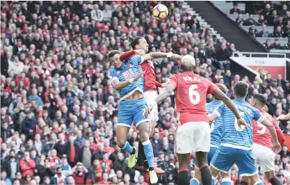  ??  ?? OLD TRAFFORD: Manchester United’s Swedish striker Zlatan Ibrahimovi­c (2L) clashes in the air with Bournemout­h’s English defender Tyrone Mings (L) during the English Premier League football match between Manchester United and Bournemout­h at Old Trafford...