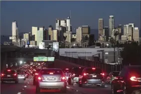  ?? AP file photo ?? Traffic moves along the 110 Freeway in Los Angeles on Nov. 22. Drivers in the U.S. and Europe are getting a break from the record-high pump prices they endured over the summer. But that price tag is still difficult for many customers who have been enduring relentless inflation and were used to lower prices.