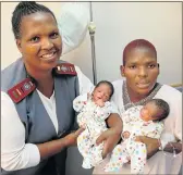  ?? PHOTOGRAPH: BRIAN WITBOOI ?? HASTY TWINS: Sister Cornelia Booi assists Fnam Vuyokazi with twin boys Amyoli and Ayolile, first of the Eastern Cape’s New Year babies, born in Uitenhage