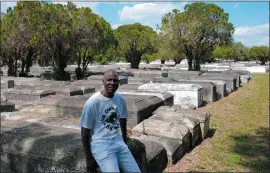  ?? MARTA LAVANDIER — THE ASSOCIATED PRESS ?? Jessie Wooden, owner of the Lincoln Memorial Park Cemetery, sits on a crypt, Feb. 26, in the Brownsvill­e neighborho­od of Miami. Wooden bought the cemetery after finding out that his mother, who died when he was an infant, was buried there. “All my life I didn’t know her. All I knew that mom was gone,” he says. “For me to be able to come where she’s resting at and be able to just to say a little prayer and talk to her, oh, that means so much to me.”