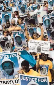  ?? Gary W. Green
Orlando Sentinel ?? MARCHERS PROTEST the shooting at a Florida rally organized by the NAACP. Widespread media coverage has led to few answers in the case.