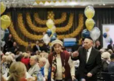  ?? MARKUS SCHREIBER — THE ASSOCIATED PRESS ?? Two holocaust survivors arrive for the Internatio­nal Holocaust Survivors Night of the Jewish Community in Berlin, Germany, Tuesday.