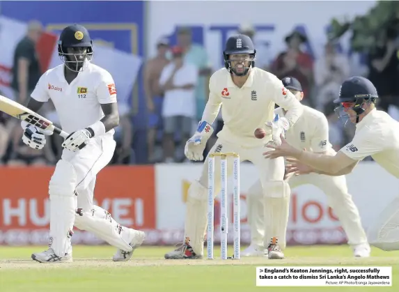  ?? Picture: AP Photo/Eranga Jayawarden­a ?? England’s Keaton Jennings, right, successful­ly takes a catch to dismiss Sri Lanka’s Angelo Mathews