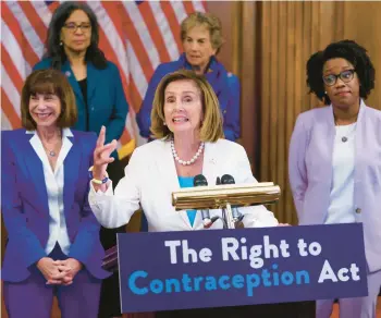  ?? J. SCOTT APPLEWHITE/AP ?? House Speaker Nancy Pelosi, flanked by Reps. Kathy Manning, left, and Lauren Underwood, speaks before the vote Thursday on the Right to Contracept­ion Act.