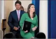  ?? ANDREW HARNIK — THE ASSOCIATED PRESS ?? White House press secretary Sarah Huckabee Sanders, right, accompanie­d by White House Deputy White press secretary Hogan Gidley, left, arrives to read a statement from President Donald Trump announcing that he is removing the security clearance from former CIA Director John Brennan during the daily press briefing at the White House, Wednesday in Washington.