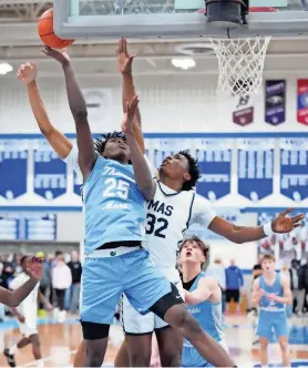  ?? SCOTT ASH / MILWAUKEE JOURNAL SENTINEL ?? St. Thomas More's Sekou Konneh (25) is fouled by Milwaukee Academy of Science's Elijah Thornton (32) during the WIAA D3 boys basketball sectional semifinal at Oak Creek High School on Thursday, March 7, 2024.