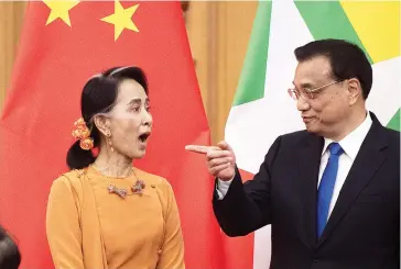  ??  ?? Myanmar State Counsellor Aung San Suu Kyi with Chinese Premier Li Keqiang during a recent ceremony in Beijing. (Reuters)