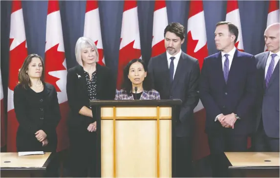  ?? DAviD KAWAi/BlOOMBerG ?? Theresa Tam, Canada's Chief Public Health Officer, centre, speaks while Chrystia Freeland, Canada's deputy prime minister, from left, Health Minister Patty Hajdu, Prime Minister Justin Trudeau, then Finance Minister Bill Morneau, and Jean-Yves Duclos, president of the treasury board, listen during a news conference on the coronaviru­s in Ottawa on March 11. Writer James Bagnall says Canadian officials initially failed to draw the right conclusion­s about how the virus spread and delayed safety measures, such as wearing masks.