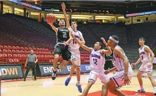  ?? XL SPORTS PHOTOGRAPH­Y ?? The final game of any kind in the state of New Mexico in 2020 was this one, the boys basketball Class 5A championsh­ip game held the night of March 14 in The Pit. The NMAA staged the final three days of the tournament without fans after the initial cases of the coronaviru­s first appeared in New Mexico on March 11.