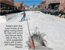  ?? ?? Today's sport features horses at full gallop towing skiers by rope over jumps and around obstacles as they try to lance suspended hoops with a baton. (AP Photo/thomas Peipert)