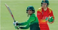  ?? AFP ?? Pakistan’s Fakhar Zaman (left) plays a shot next to Zimbabwe’s keeper Ryan Murray in the ODI series in Bulawayo in July. —