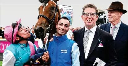  ??  ?? Star filly: Dettori kisses Enable after her Irish Oaks win, to the amusement of trainer Gosden (right), groom Imran Shahwani (centre) and owner Khalid Abdullah’s racing manager Lord Grimthorpe